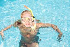 Happy woman with snorkel gear swimming in pool