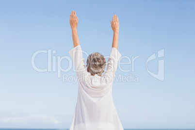 Casual senior woman with arms outstretched