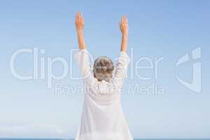 Casual senior woman with arms outstretched