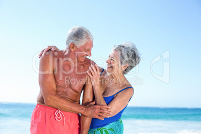 Cute mature couple embracing on the beach