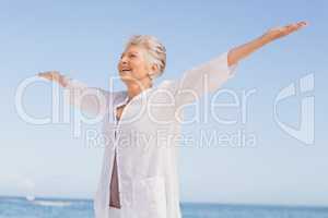 Casual senior woman with arms outstretched