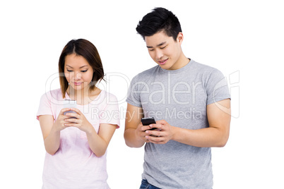 Young couple text messaging on mobile phone