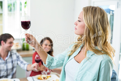 Woman holding red wine glass