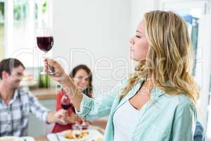 Woman holding red wine glass