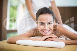 Young woman smiling while receiving massage