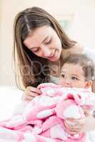 Happy mother and baby with blanket