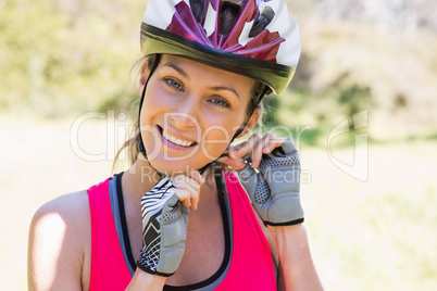 Fit smiling woman wearing helmet