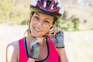 Fit smiling woman wearing helmet