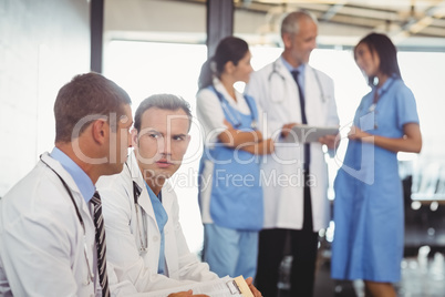 Two doctors with clipboard and discussing