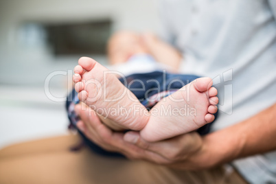 Midsection of father holding baby