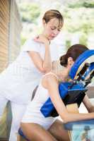 Female physiotherapist giving back massage