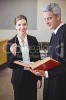 Female lawyer standing by male colleague