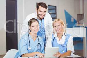 Portrait of cheerful doctor colleagues with digital tablet