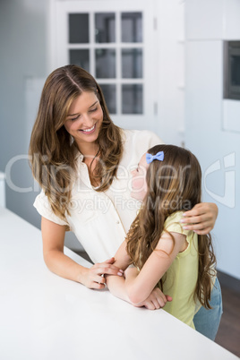 Smiling woman looking at daughter