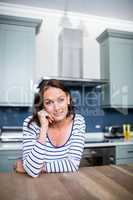 Portrait of smiling young woman sitting at table