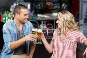 Cute couple toasting with beers