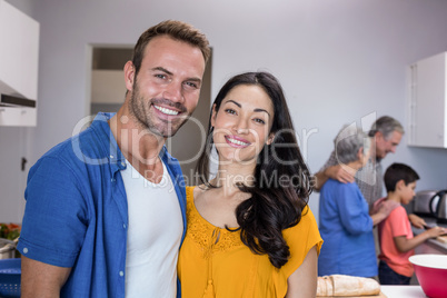 Young man and young woman standing in kitchen