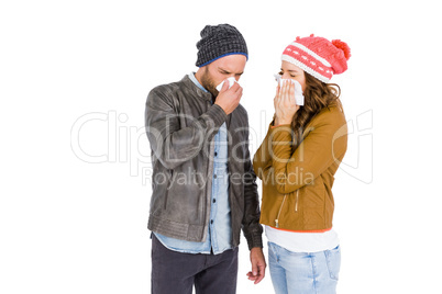 Sick young couple blowing nose