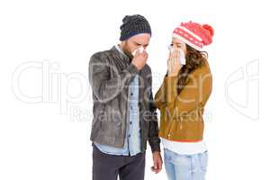 Sick young couple blowing nose
