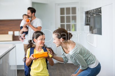 Smiling mother talking to daughter