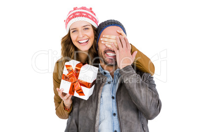 Woman giving a surprise gift to her man