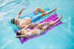 Couple relaxing on inflatable raft
