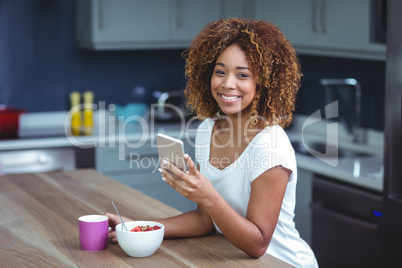 Portrait of happy woman using smartphone with food