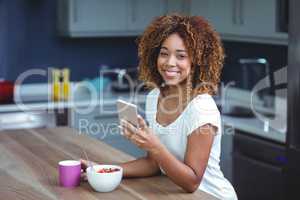 Portrait of happy woman using smartphone with food