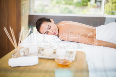 Young woman lying on massage table