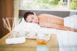 Young woman lying on massage table