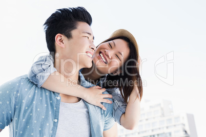 Young man giving a piggyback ride to woman