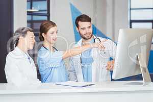 Doctor team discussing at computer desk