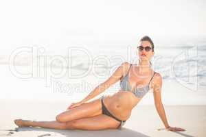 Glamorous woman sitting on the beach