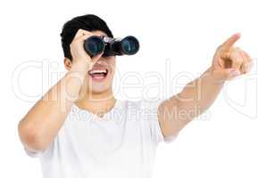 Young man looking through binocular