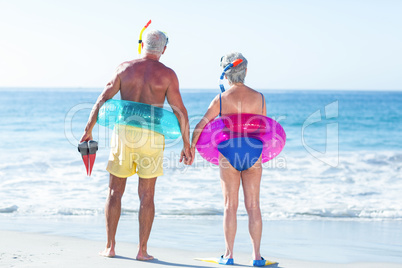 Senior couple with beach equipment