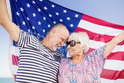 Senior couple holding american flag together