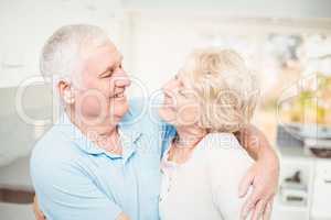 Happy senior couple smiling while looking at eachother