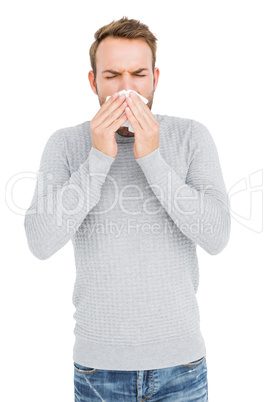 Young man wiping his nose