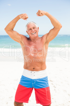 Senior man posing with his muscles