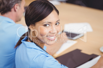 Happy female doctor sitting on conference room Happy female doctor sitting on conference room