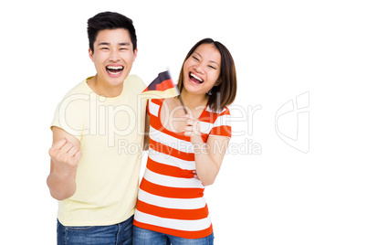 Excited couple holding flag