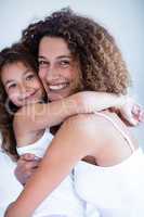 Portrait of mother and daughter embracing