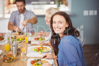 Happy woman having breakfast with family