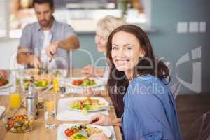 Happy woman having breakfast with family