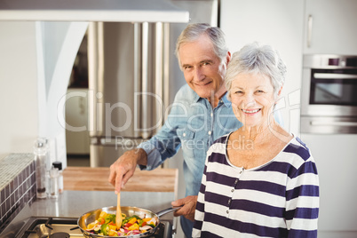 Portrait of senior couple cooking food