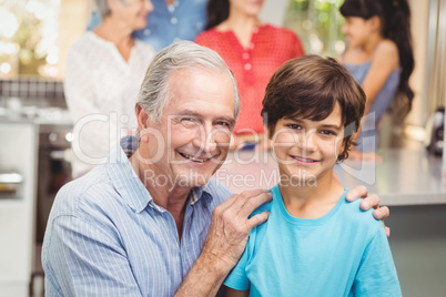 Portrait of grandfather and grandson with family