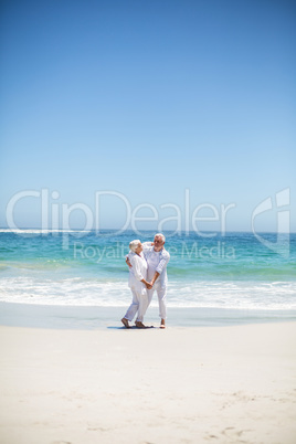 Senior couple dancing at the beach