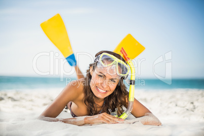 Smiling woman wearing flippers at the beach