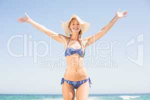 Carefree woman in bikini standing on the beach