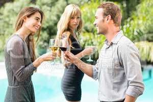 Jealous woman looking at happy couple toasting wine